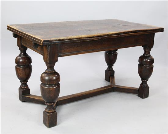 An early 17th century style draw leaf refectory table, Ext. L. 8ft 6in. W 2ft 6in. H. 2ft 7in.
